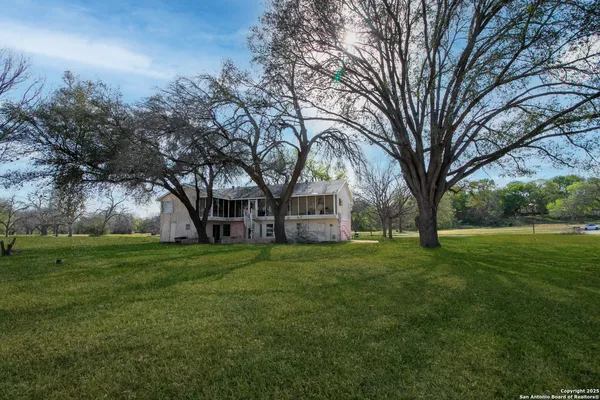 a view of a house with a yard