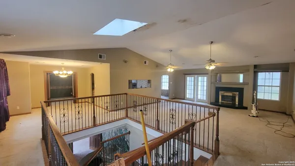 a view of an entryway wooden floor and chandelier