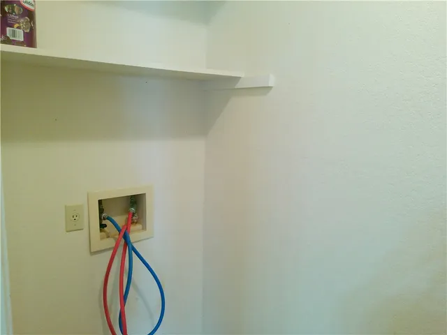 a close up of a wall with a washer and dryer