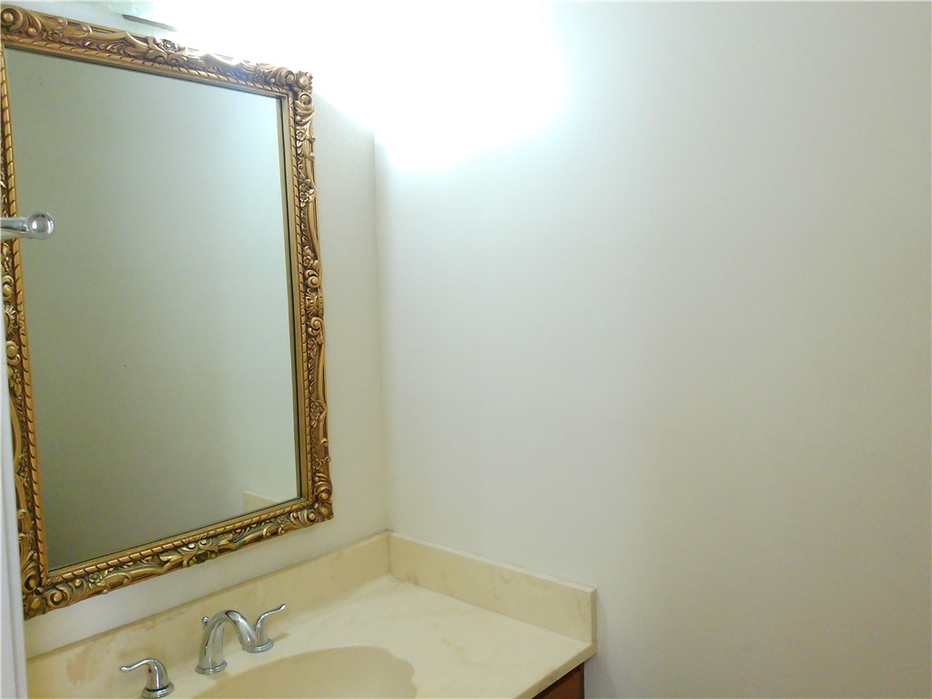 2936 St Joseph Street, Unit B Corpus Christi, TX 78418 - Photo 5 of 15 a bathroom with a sink and a mirror
