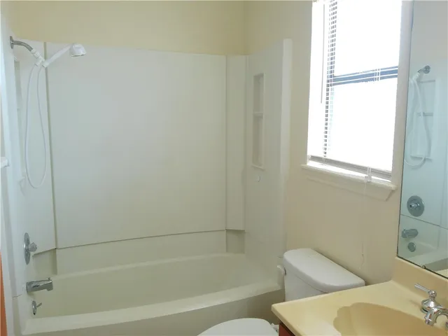 a bathroom with a toilet and a bathtub