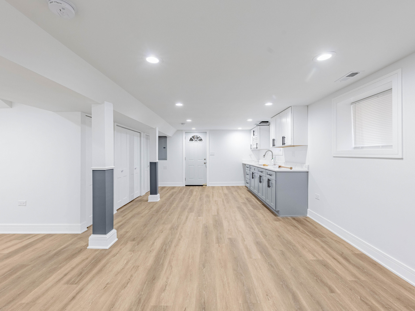 7755 South Wolcott Avenue Chicago, IL 60620 - Photo 26 of 39 a large white kitchen with kitchen island a sink stainless steel appliances and cabinets