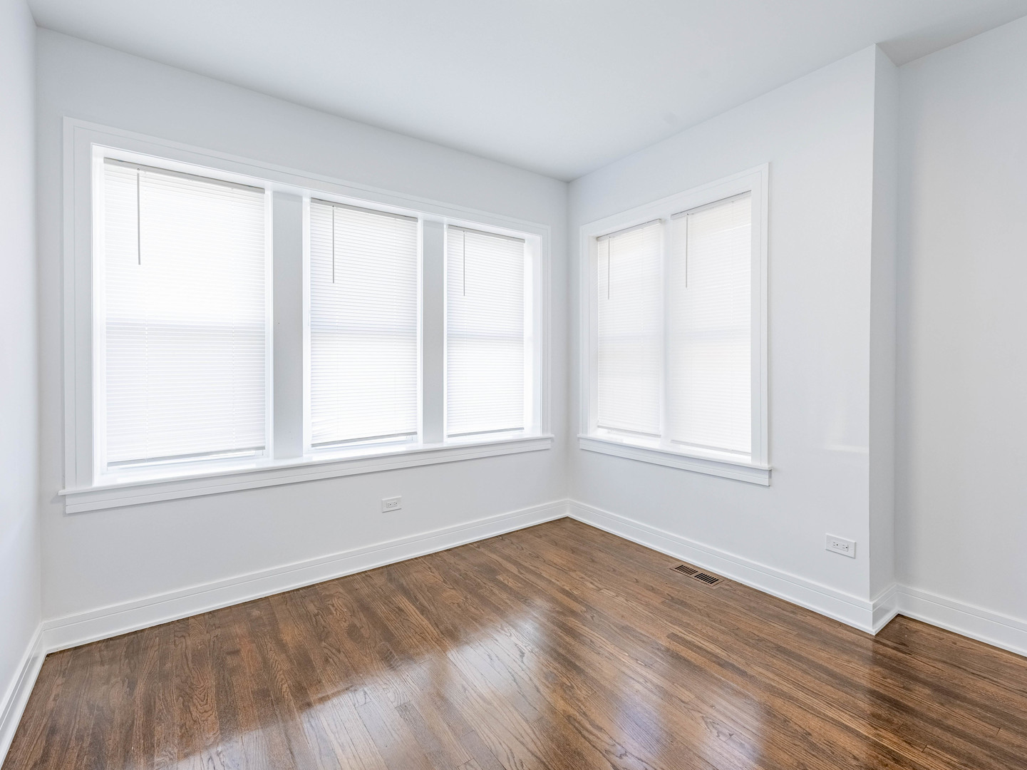 7755 South Wolcott Avenue Chicago, IL 60620 - Photo 29 of 39 an empty room with wooden floor and windows