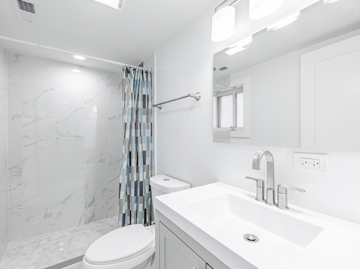 7755 South Wolcott Avenue Chicago, IL 60620 - Photo 36 of 39 a bathroom with a sink toilet vanity and shower