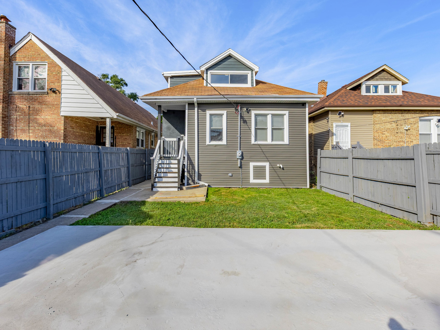 7755 South Wolcott Avenue Chicago, IL 60620 - Photo 38 of 39 a front view of a house with a yard and garage