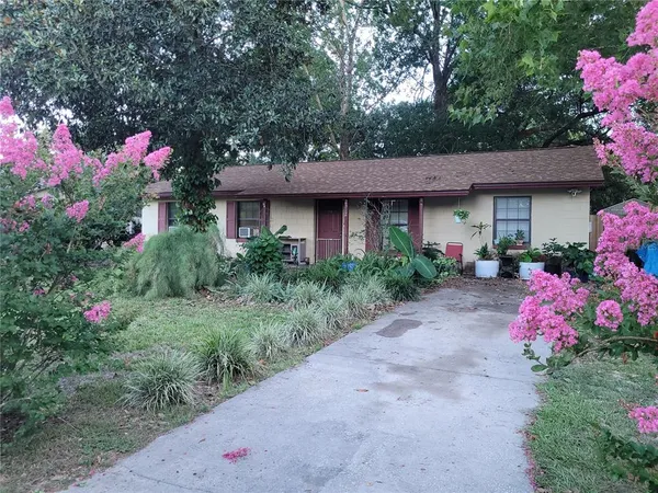 a front view of a house with a yard and fountain