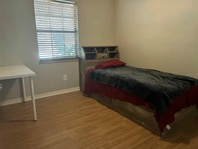 a bed sitting in a bedroom next to a window