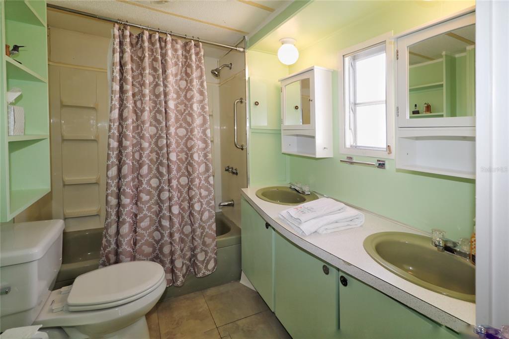 116 West St Johns Way Apollo Beach, FL 33572 - Photo 16 of 28 a bathroom with a granite countertop toilet sink and mirror