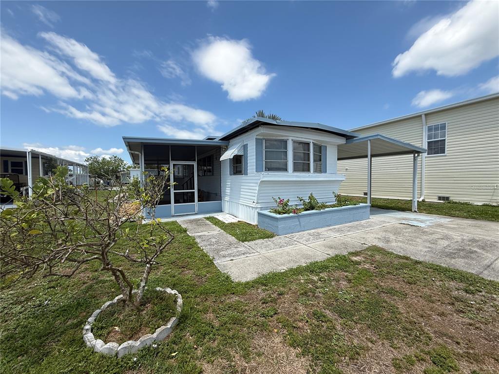 116 West St Johns Way Apollo Beach, FL 33572 - Photo 20 of 28 a front view of a house with a yard and potted plants