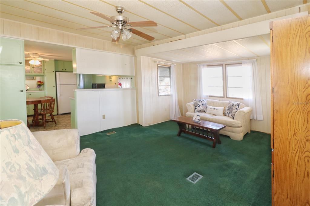 116 West St Johns Way Apollo Beach, FL 33572 - Photo 6 of 28 a living room with furniture and a chandelier