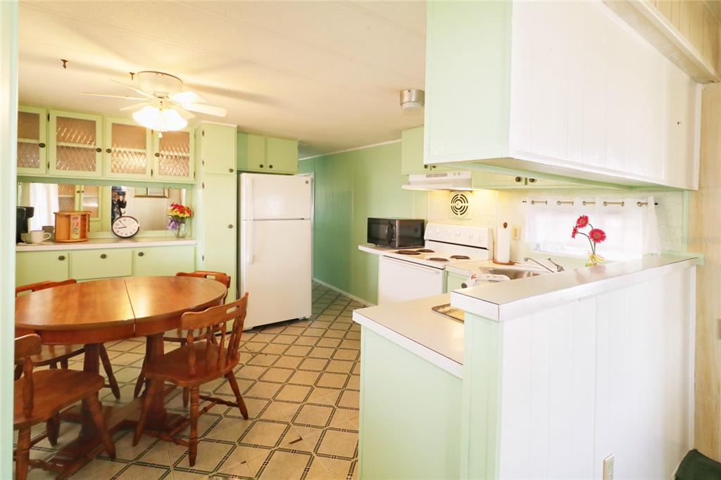 116 West St Johns Way Apollo Beach, FL 33572 - Photo 7 of 28 a kitchen with a sink a stove and white cabinets