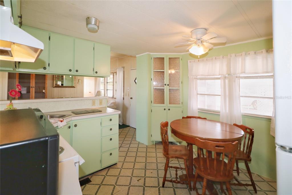 116 West St Johns Way Apollo Beach, FL 33572 - Photo 8 of 28 a kitchen with a table chairs and a refrigerator