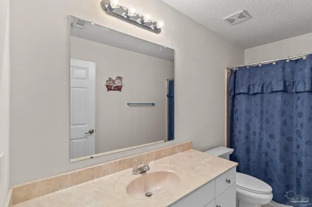 a bathroom with a sink toilet and vanity
