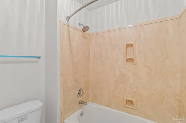a bathroom with a shower curtain and a toilet