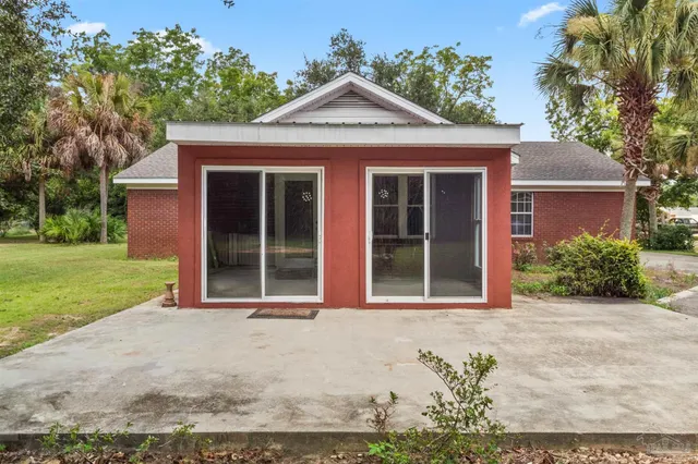 front view of a brick house with a yard