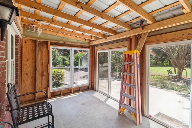 a living room with furniture and a backyard