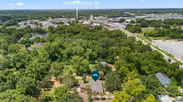 an aerial view of a house with a yard