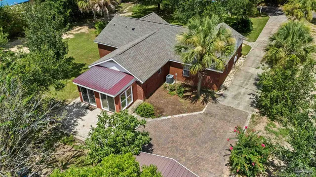 an aerial view of a house with a yard and lake view