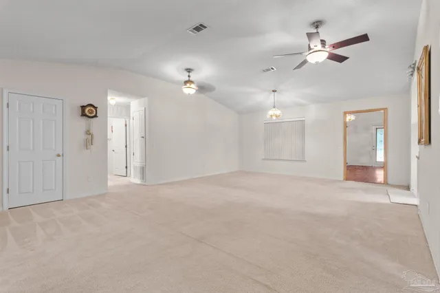 a view of an empty room with a ceiling fan