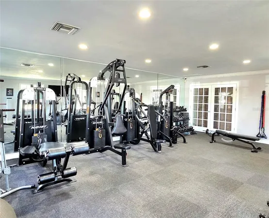 a room with gym equipment and a large window