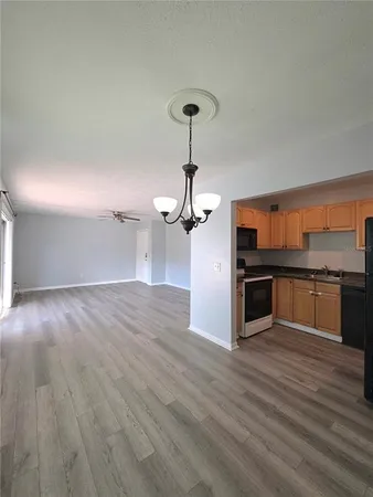 a view of a kitchen with a sink and wooden floor