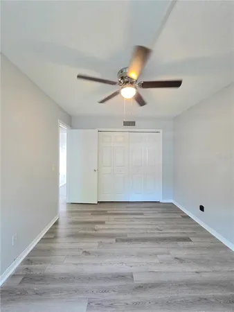 a view of an empty room with window chandelier fan