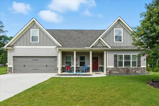 a front view of a house with a yard and garage