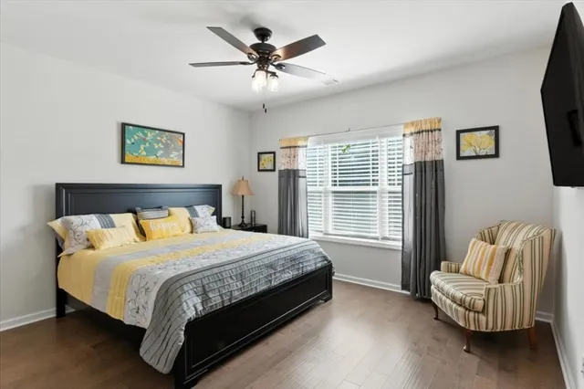 a bathroom with a granite countertop sink a toilet and a shower