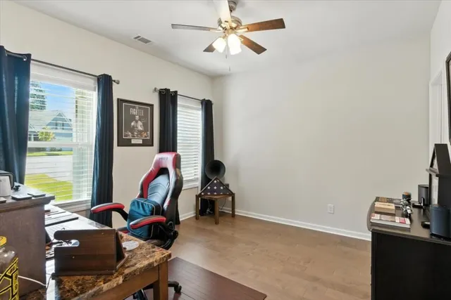 a bathroom with a granite countertop sink toilet and mirror