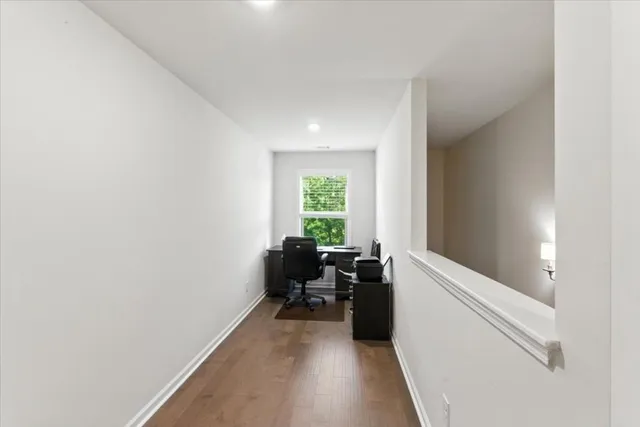 a living room with furniture a fireplace and a large window