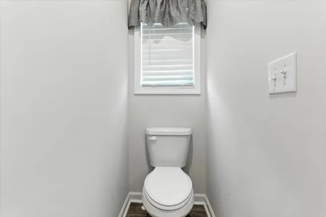 a living room with furniture a fireplace and a floor to ceiling window