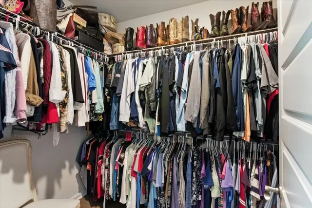 a view of a patio with table and chairs potted plants and floor to ceiling window
