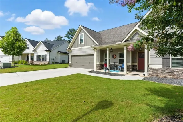 a view of a house with a yard and sitting area