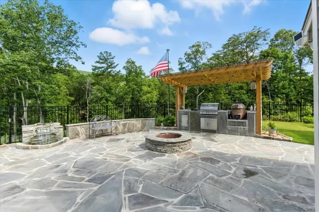 an aerial view of a house with outdoor space and a lake view
