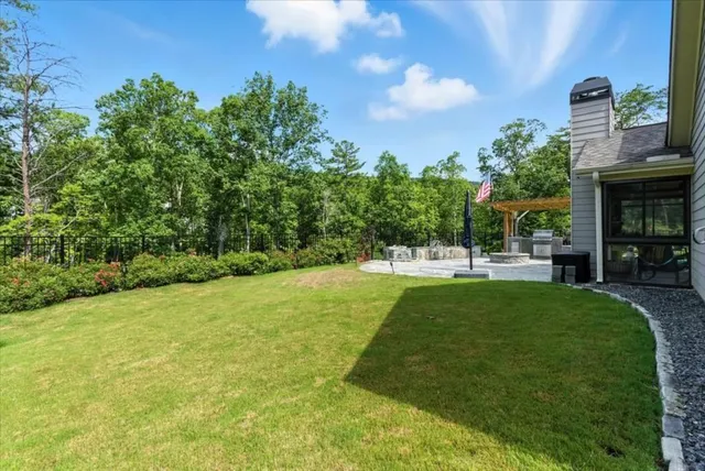 an aerial view of a residential houses with outdoor space