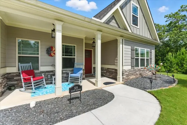a front view of a house with outdoor seating