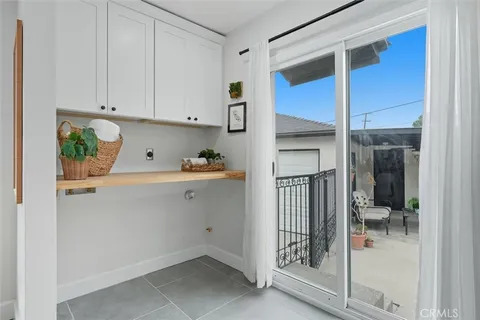 a view of a patio with table and chairs under an umbrella