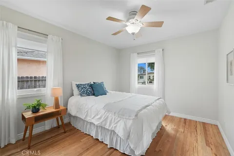 a bedroom with a large bed and a ceiling fan