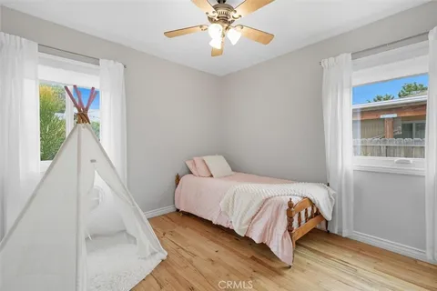 a view of a room with wooden floor and a window