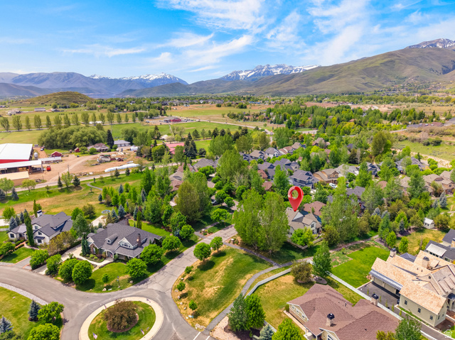 557 Craftsman Way Midway, UT 84049 - Photo 55 of 59 Aerial perspective of a residential community with abundant mature trees and verdant green spaces