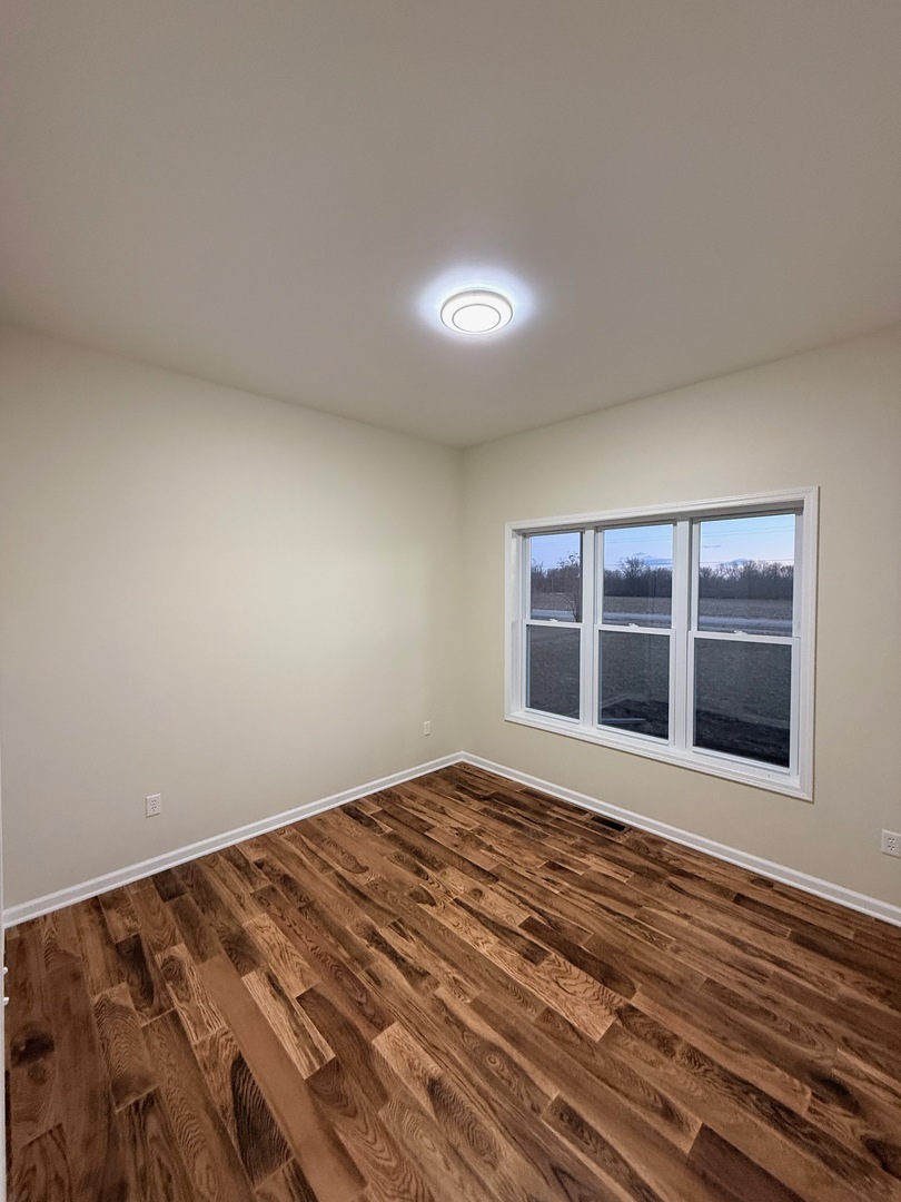692 Penrose Road Dixon, IL 61021 - Photo 13 of 25 a view of an empty room with wooden floor and windows