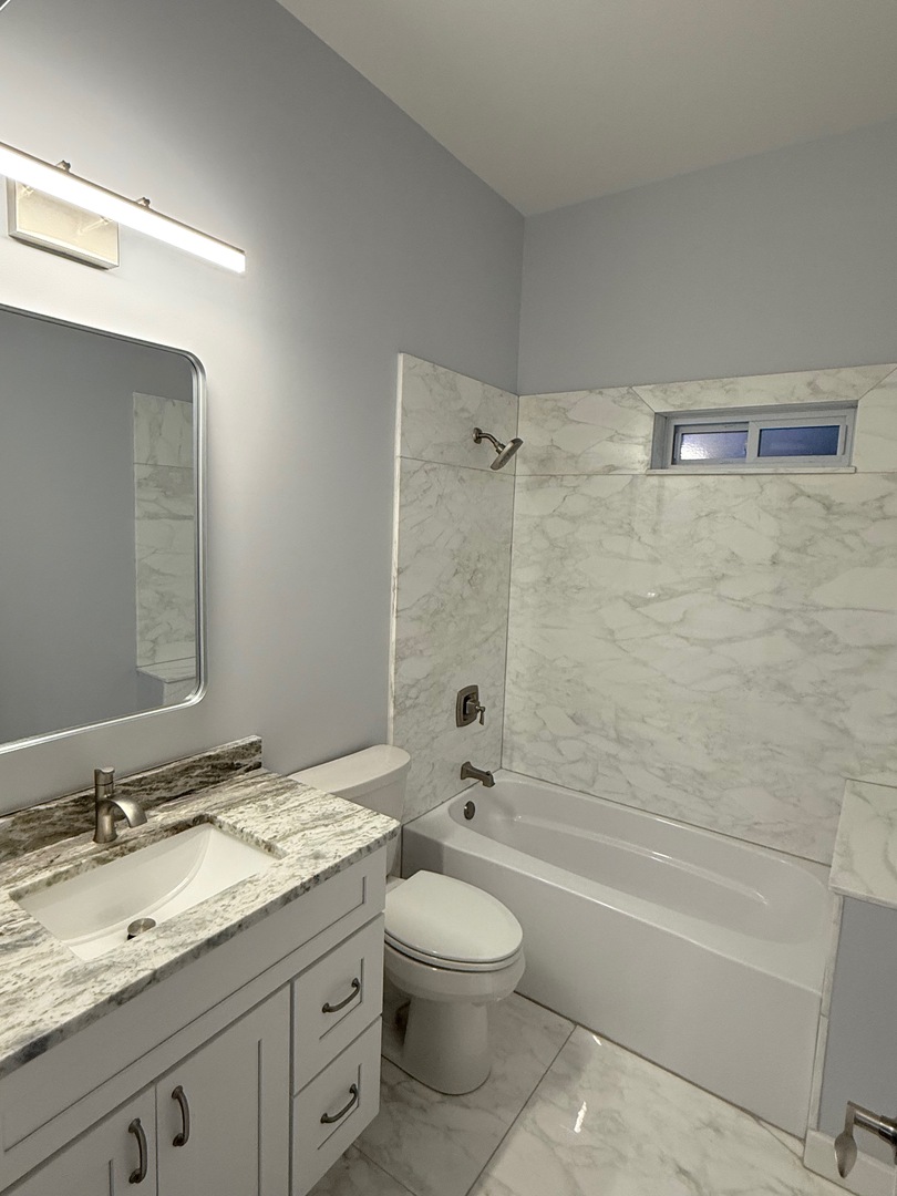 692 Penrose Road Dixon, IL 61021 - Photo 18 of 25 a bathroom with a granite countertop sink a toilet and bathtub