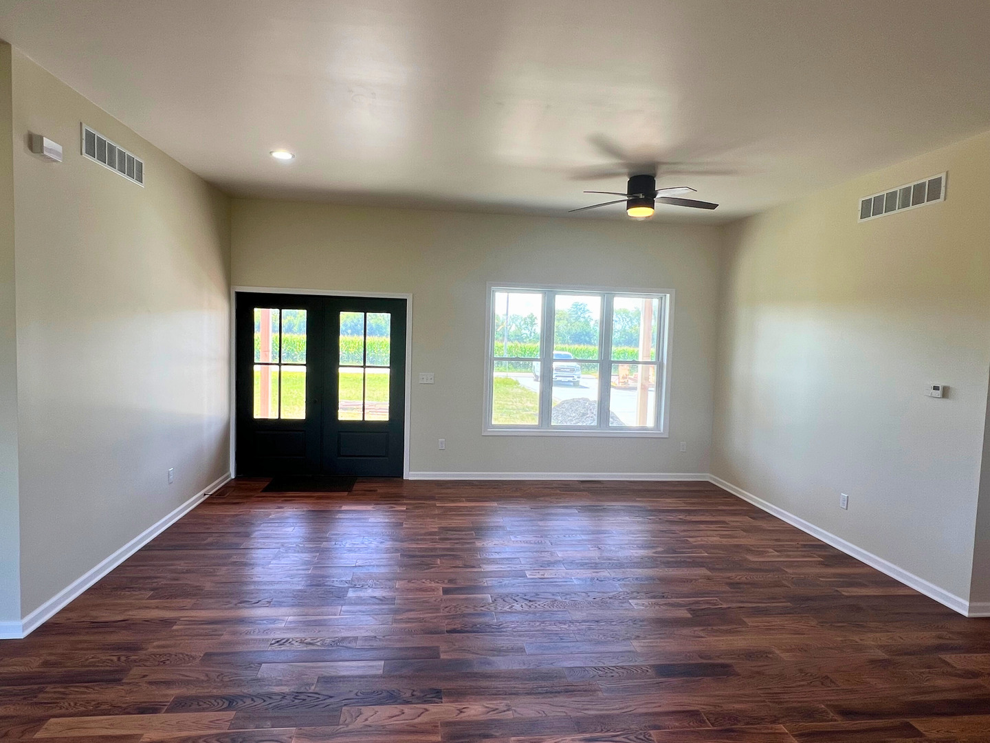 692 Penrose Road Dixon, IL 61021 - Photo 3 of 25 a view of an empty room with wooden floor and a window