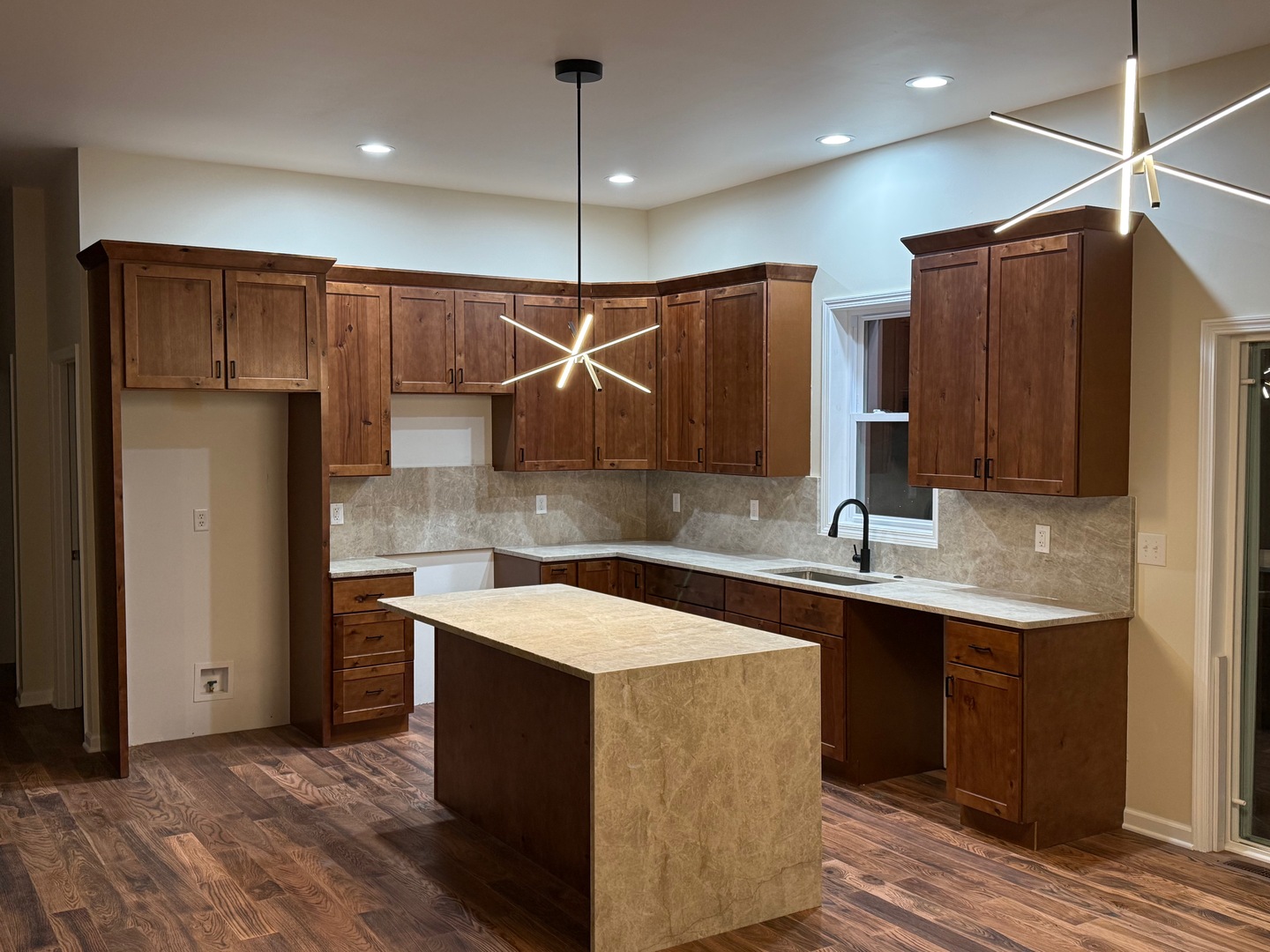 692 Penrose Road Dixon, IL 61021 - Photo 4 of 25 a kitchen with stainless steel appliances a sink a refrigerator a center island and cabinets