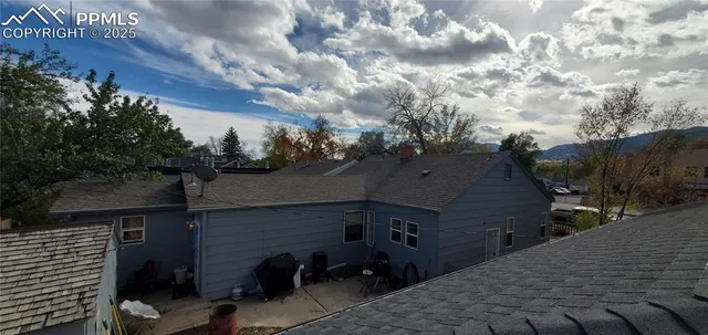 a view of house with yard and sitting area