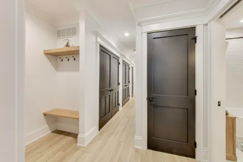 a view of a hallway with wooden floor and staircase