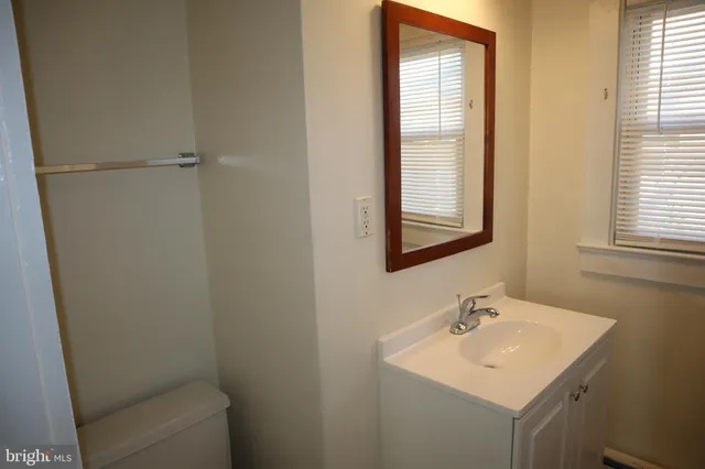 a bathroom with a sink toilet and vanity