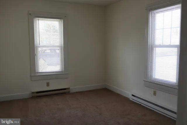 a view of an empty room and a window