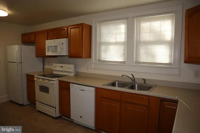a kitchen with stainless steel appliances a sink stove and cabinets