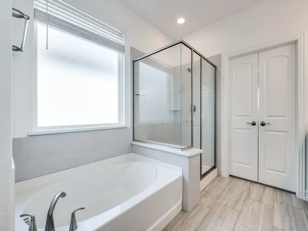 a bathroom with a bathtub and a shower